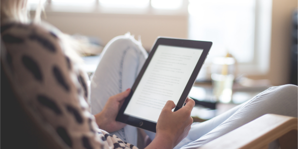 A person reading from a digital tablet device.