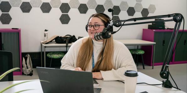 Young women using podcasting equipment