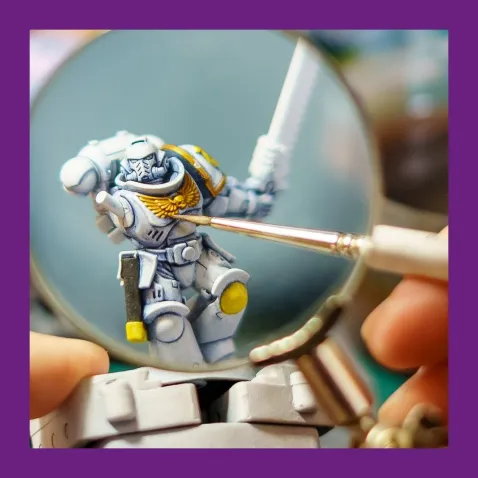 A closeup photo of a miniature being painted